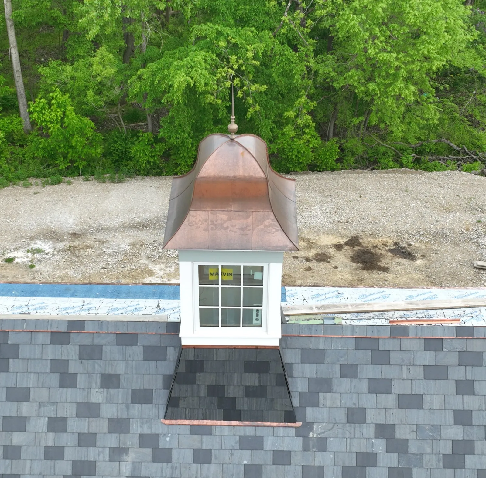 Fabricated copper cupola roof and copper flashing on a slate roof