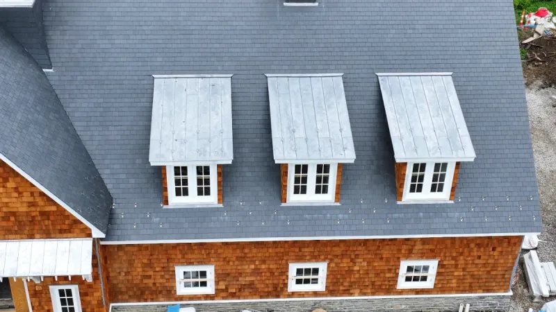 1" double lock standing seam metal roofs on dormers of a shingled house
