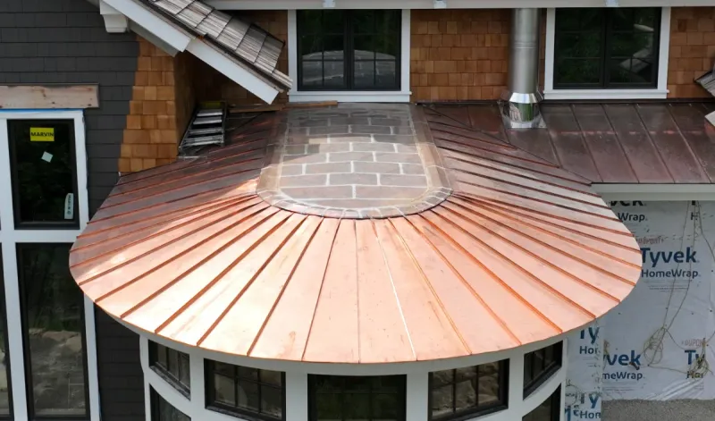 1.5" double lock standing seam copper roof on a curved bay
