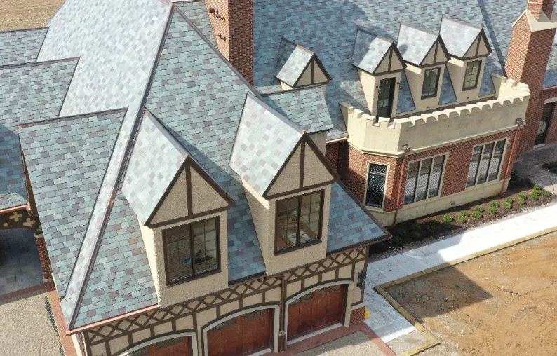 Slate roof with fabricated metal dormer trim and flashing